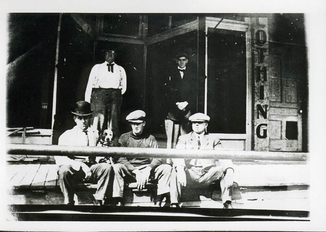 Pictured here are some fellas who must surely be patrons of VanAmberg Bros. Tailors as they look pretty dapper!  This is where Henny’s Yarn Shop is located.  The door just to the east is the stairway entrance to the Kennedy Hall which was on the second floor.